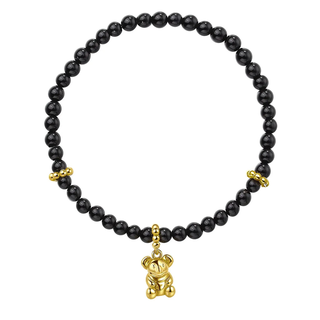 Black beaded bracelet with gold Koala charm on a white background