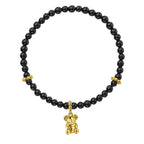Black beaded bracelet with gold Koala charm on a white background