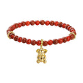 A red beaded bracelet with a gold-plated koala charm