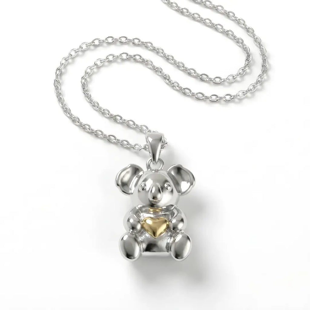 Silver Koala pendant with a 10k gold heart on a white background