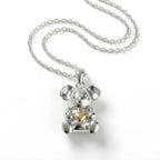 Silver Koala pendant with a 10k gold heart on a white background