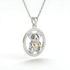 Silver pendant with a Koala and 10k gold heart cz circle on a white background